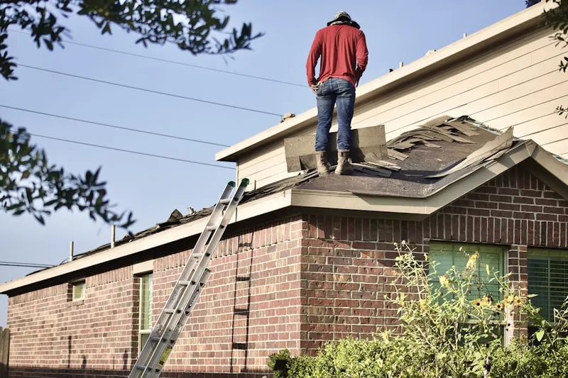 Professional roofer working on a residential roof in Fort George G Mead Junction